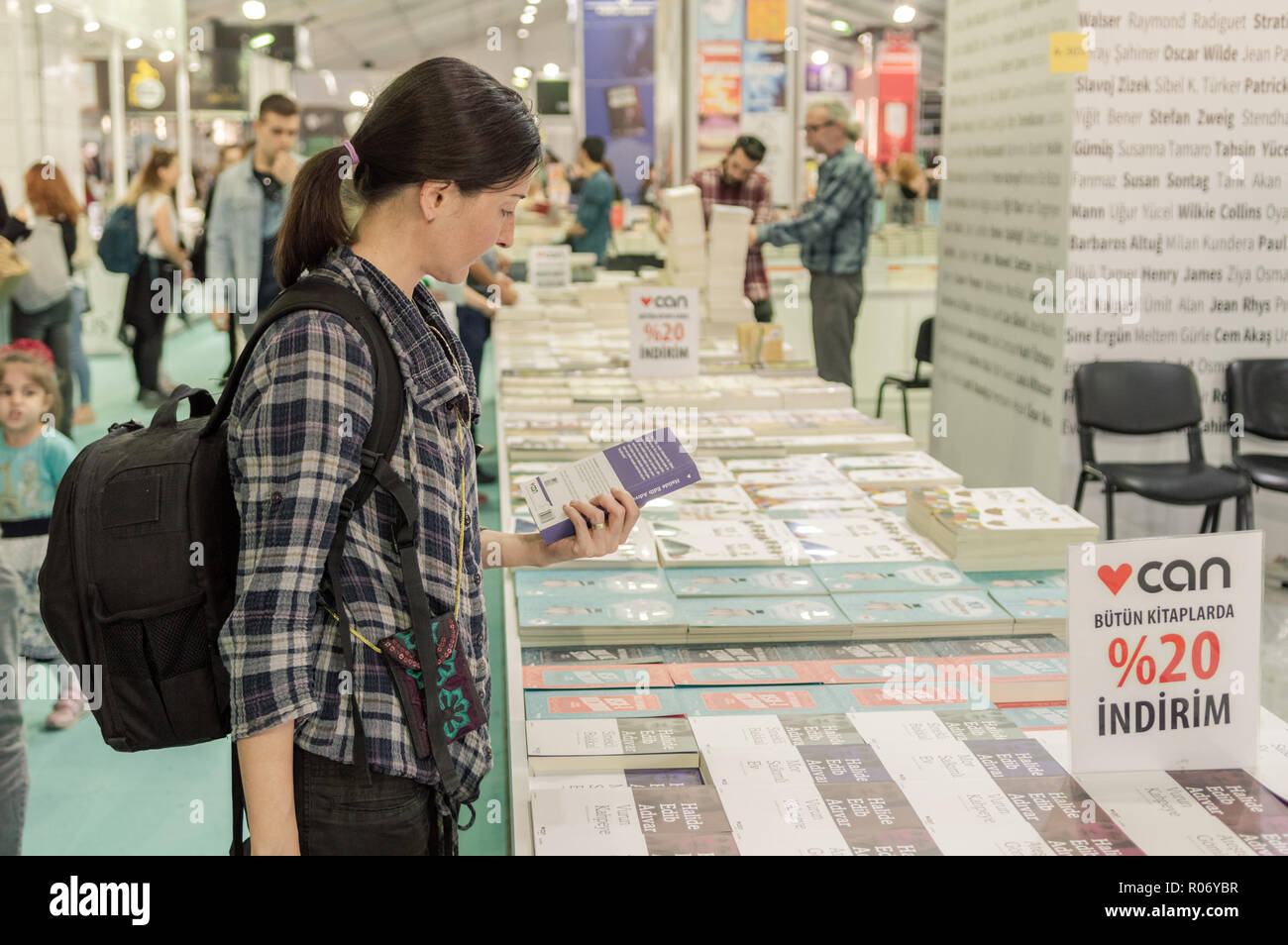 Eskisehir, Turkey - October 09, 2018: Young Caucasian woman examining a book at Eskisehir Book Fair Stock Photo