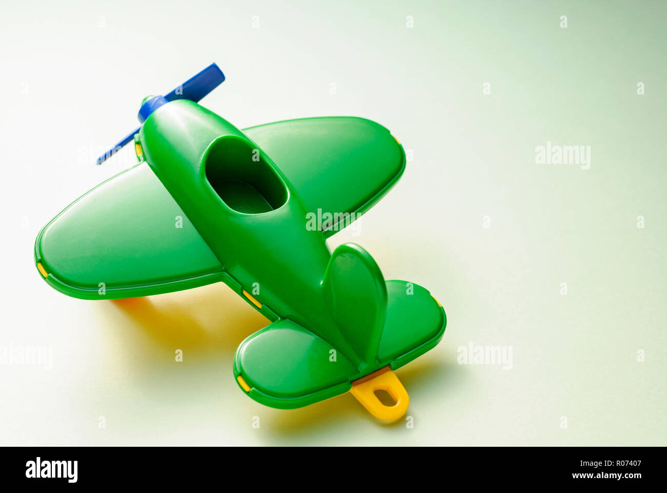 Children's toy green plane on a gradient green background Stock Photo ...