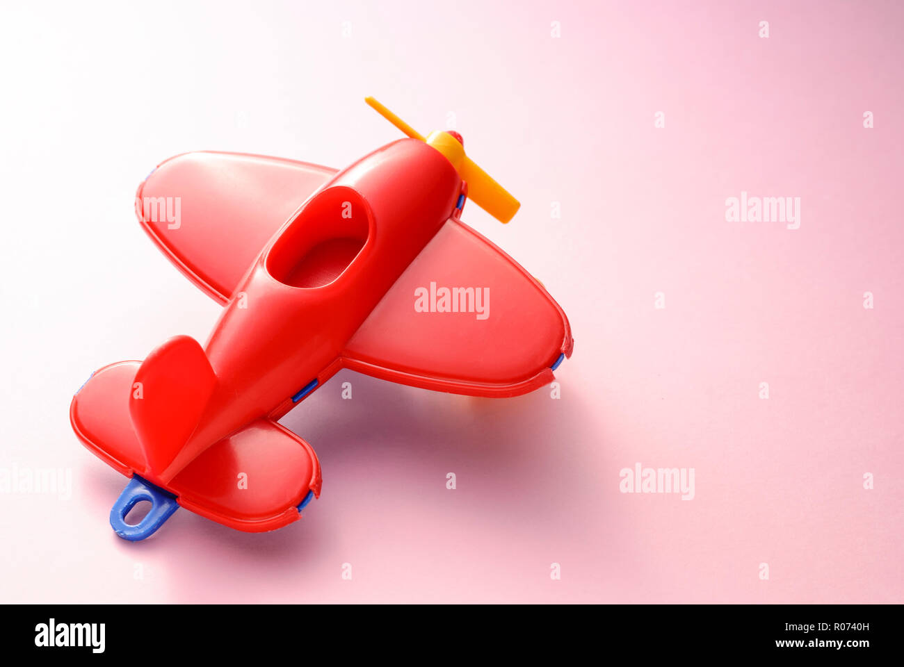 Children&rsquo;s toy red plane on a pink gradient background Stock Photo - Alamy