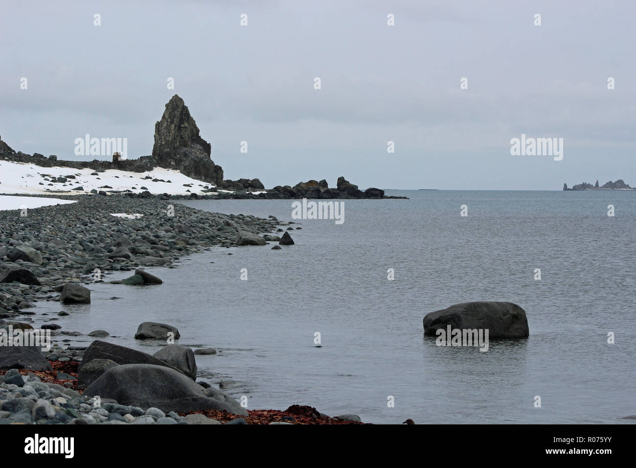 An isolated rocky beach in the South Shetland Islands, Antarctic Peninsula with snow on the ground Stock Photo