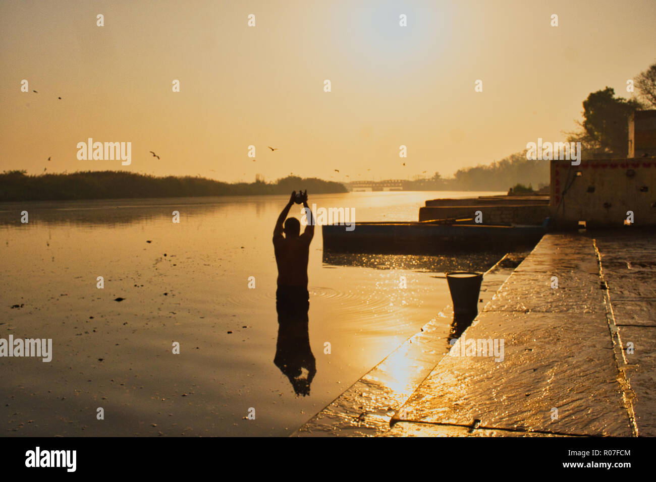 Hindu Morning prayer during sunrise in Yamuna Ghat river in New Delhi, India. Stock Photo