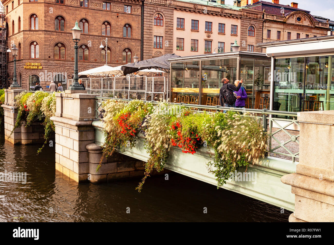14 September 2018: Gothenburg, Sweden - The German Bridge, or Tyska Bron, with a floral display and tourists, crossing the Stora Hamn Canal. Stock Photo