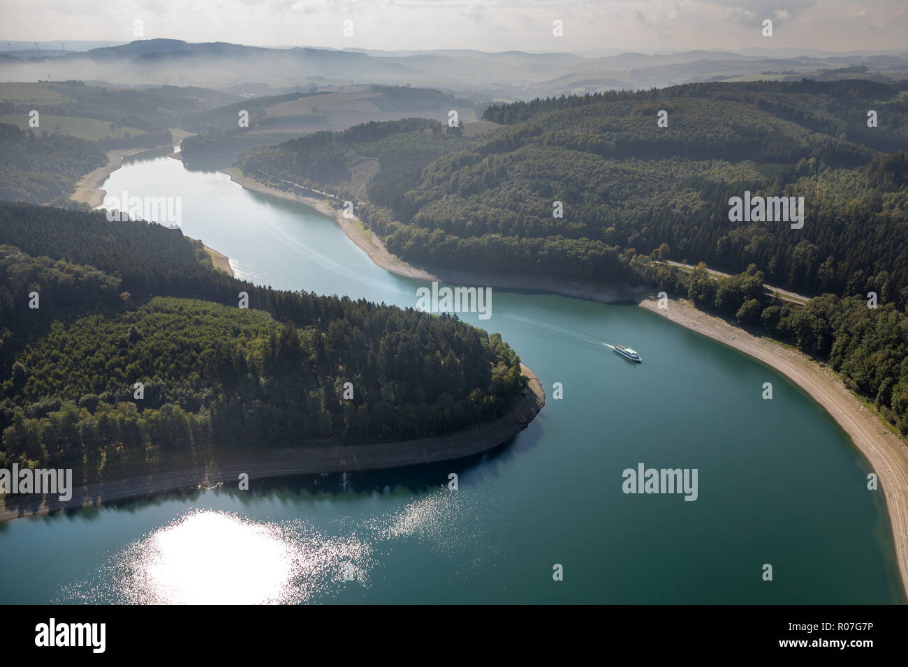 Aerial view, tour boat on the reservoir, lake, Hennesee in the nature park Sauerland-Rothaargebirge dams the water of the hen, reservoir, Hennesee at  Stock Photo