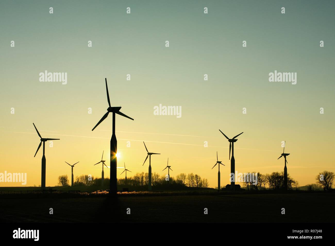 Silhouettes of a group of wind turbines at sunset Stock Photo - Alamy