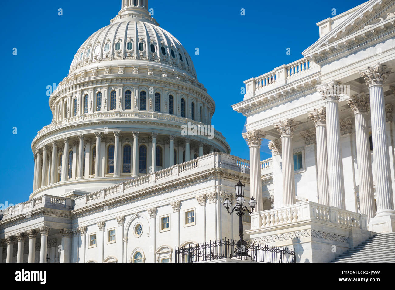 Bright blue sky view of the US Capitol Building under midday sun in