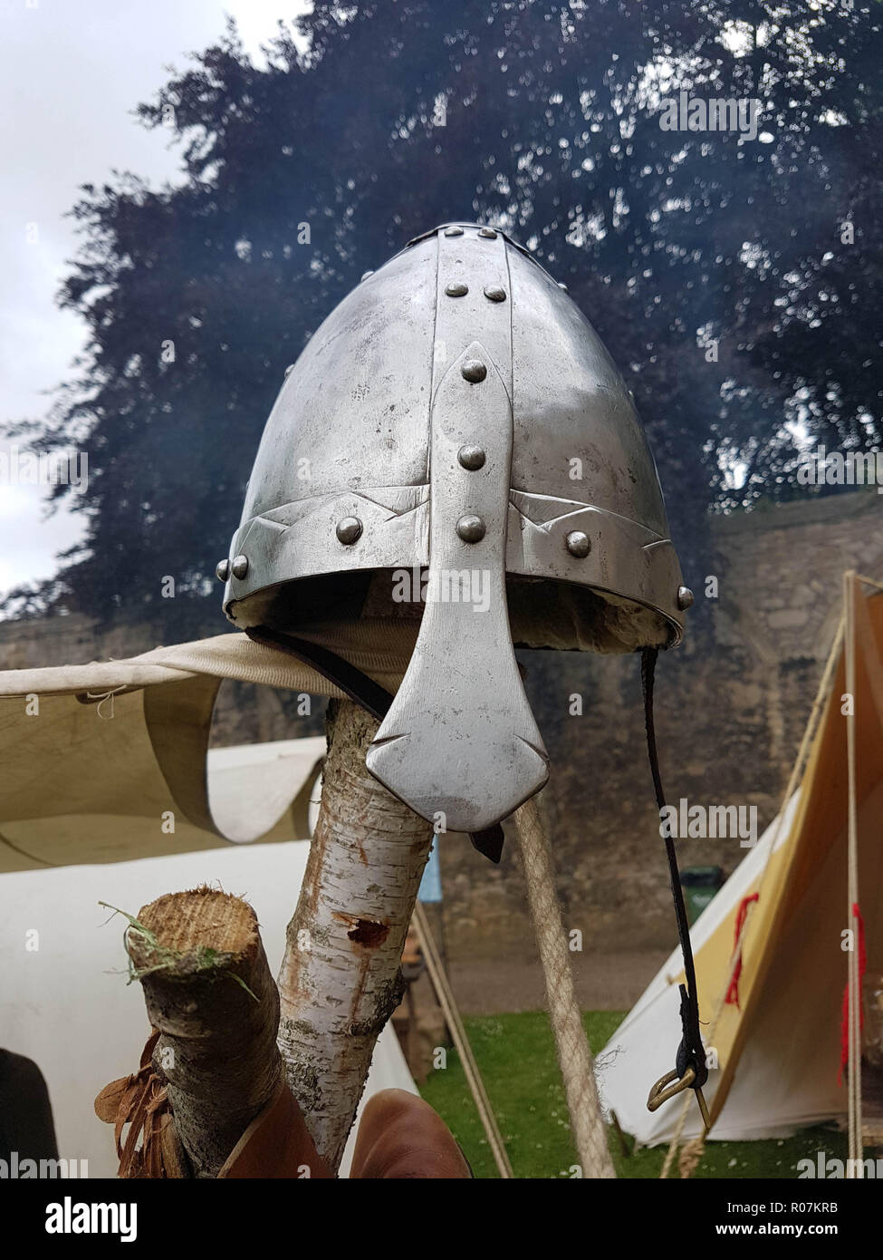 An iron knights helmet on a wooden pole. Stock Photo