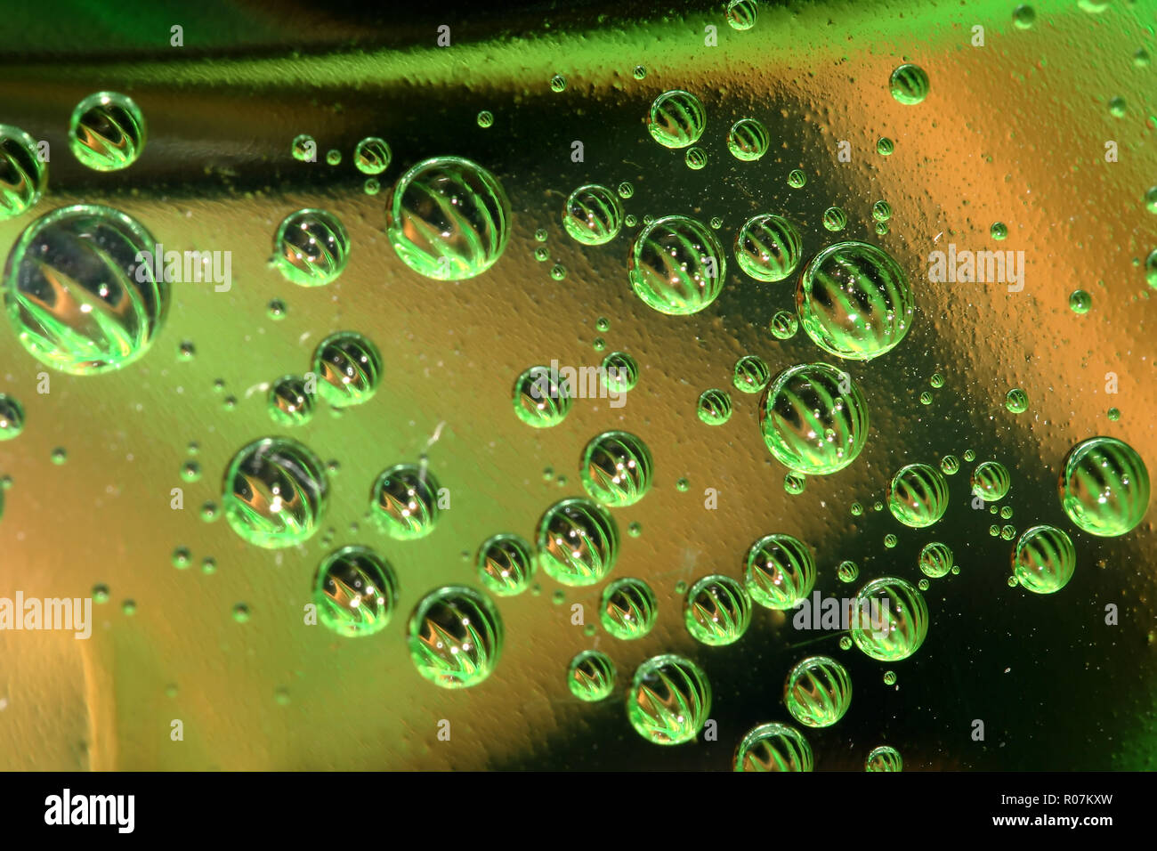 Green and yellow bubbles in plastic bottle Stock Photo