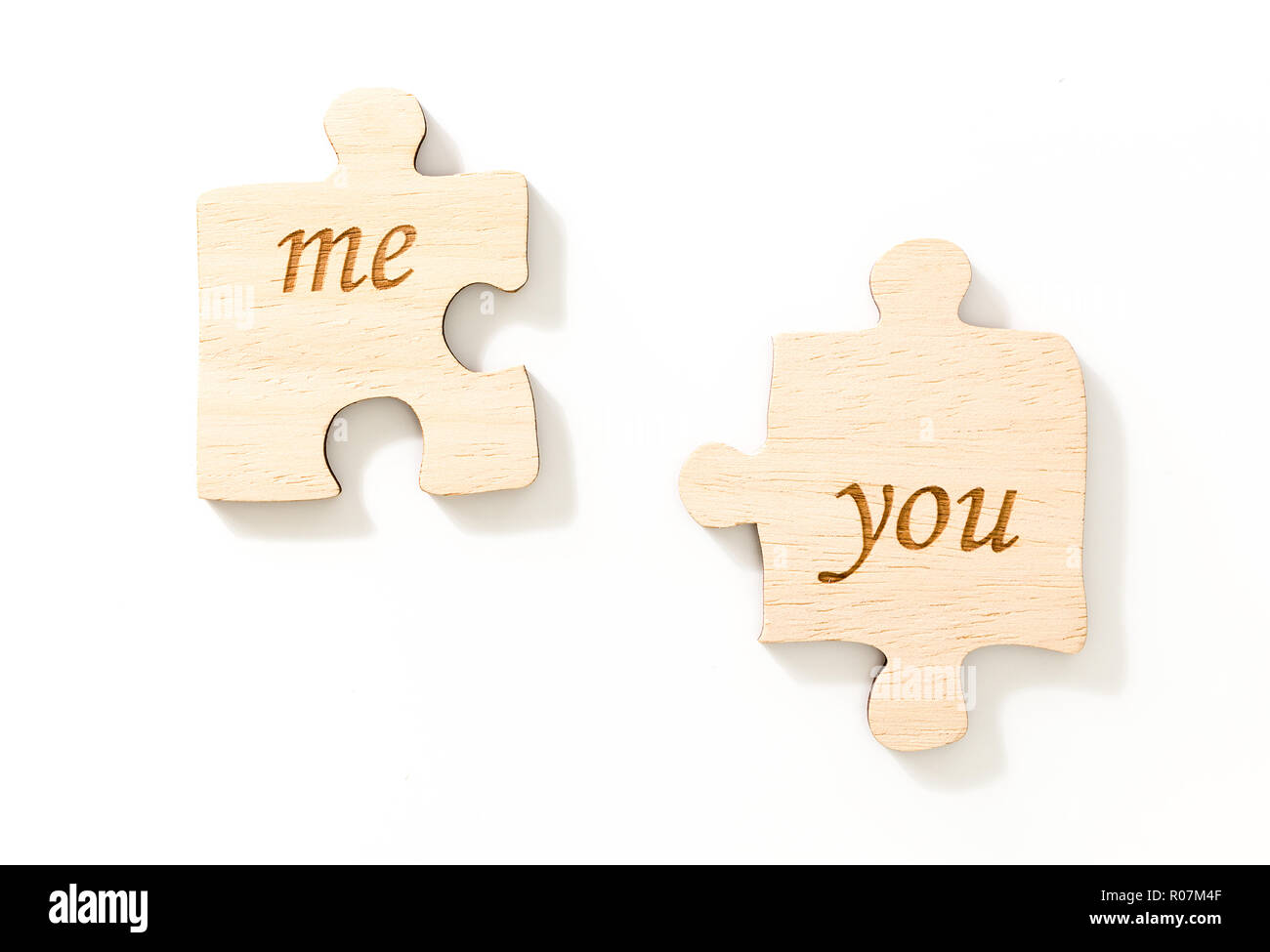 Two pieces of wooden puzzle, with text me & you, on white background Stock  Photo - Alamy