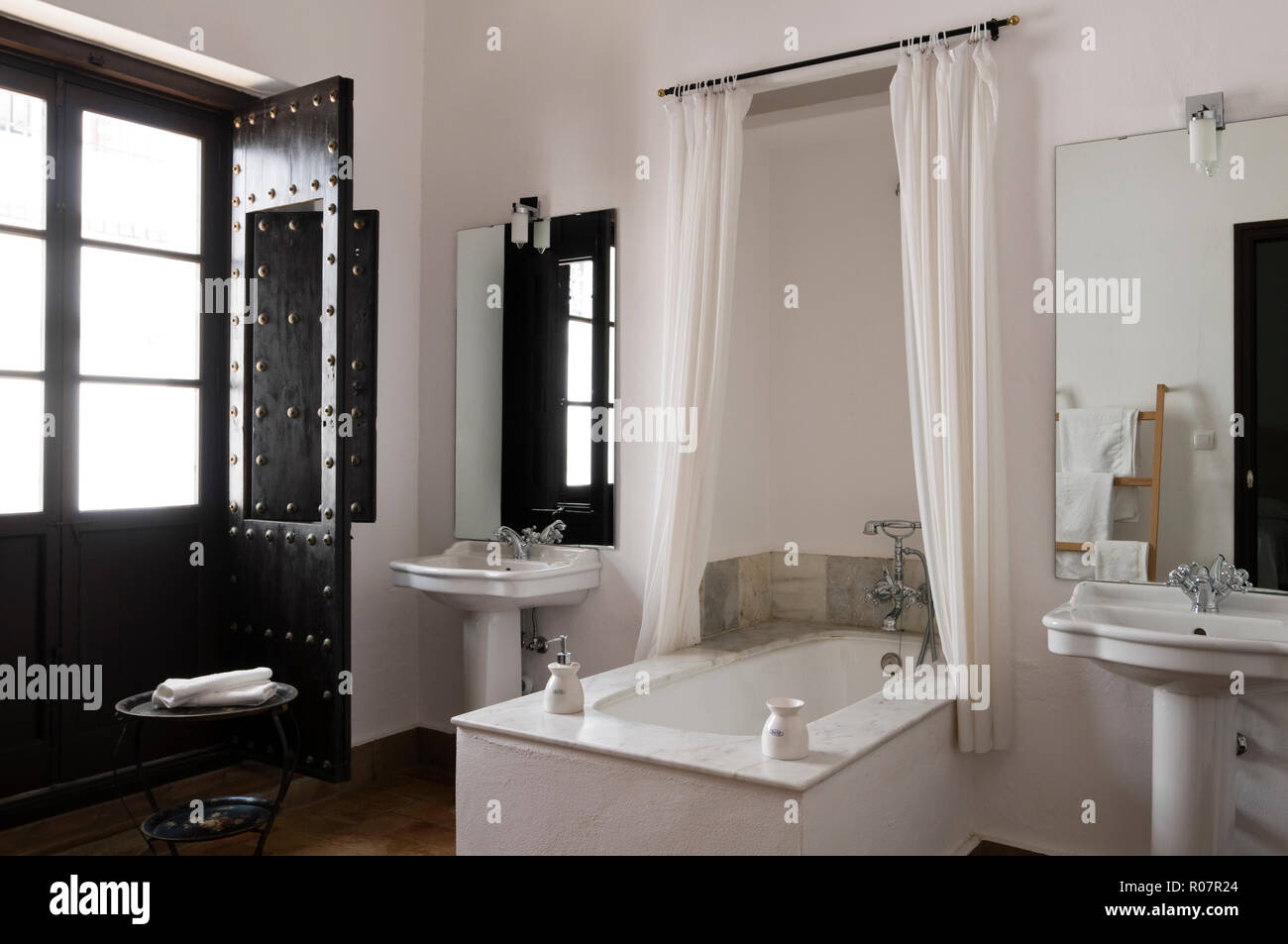 Recessed bathtub in monochrome bathroom Stock Photo - Alamy
