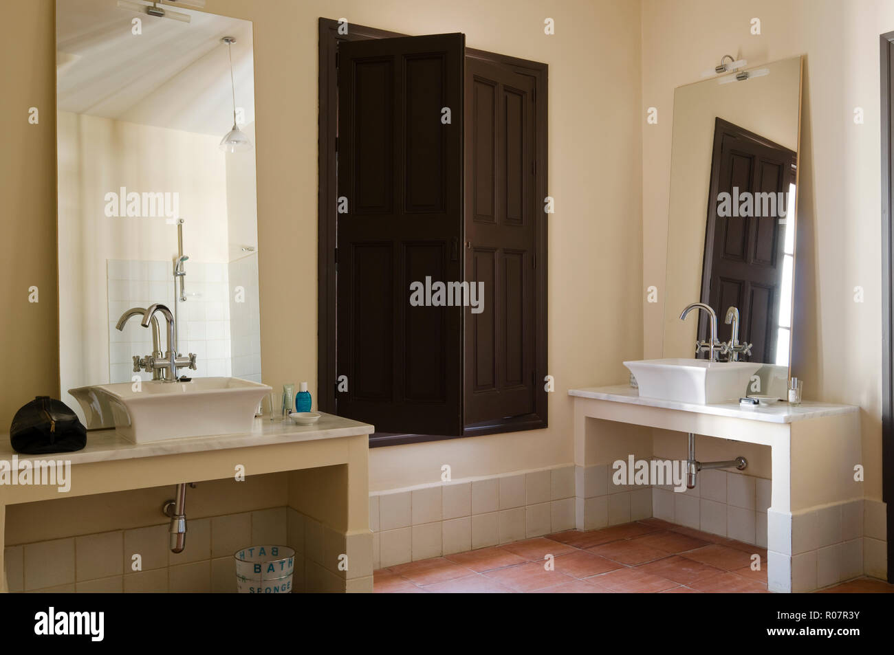 Two sinks by wooden shutters in bathroom Stock Photo