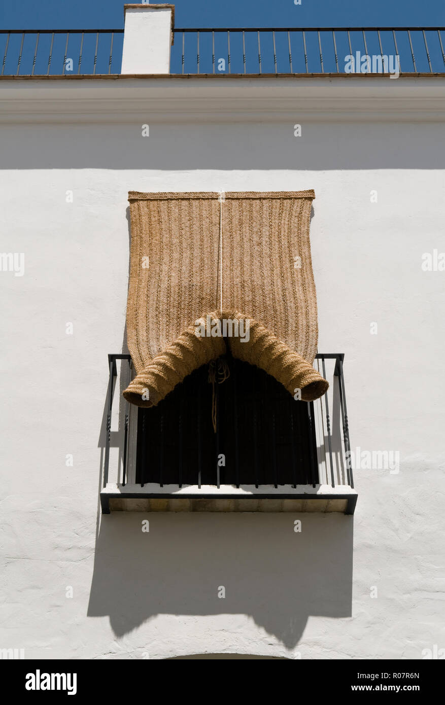 Woven blinds hanging over balcony Stock Photo