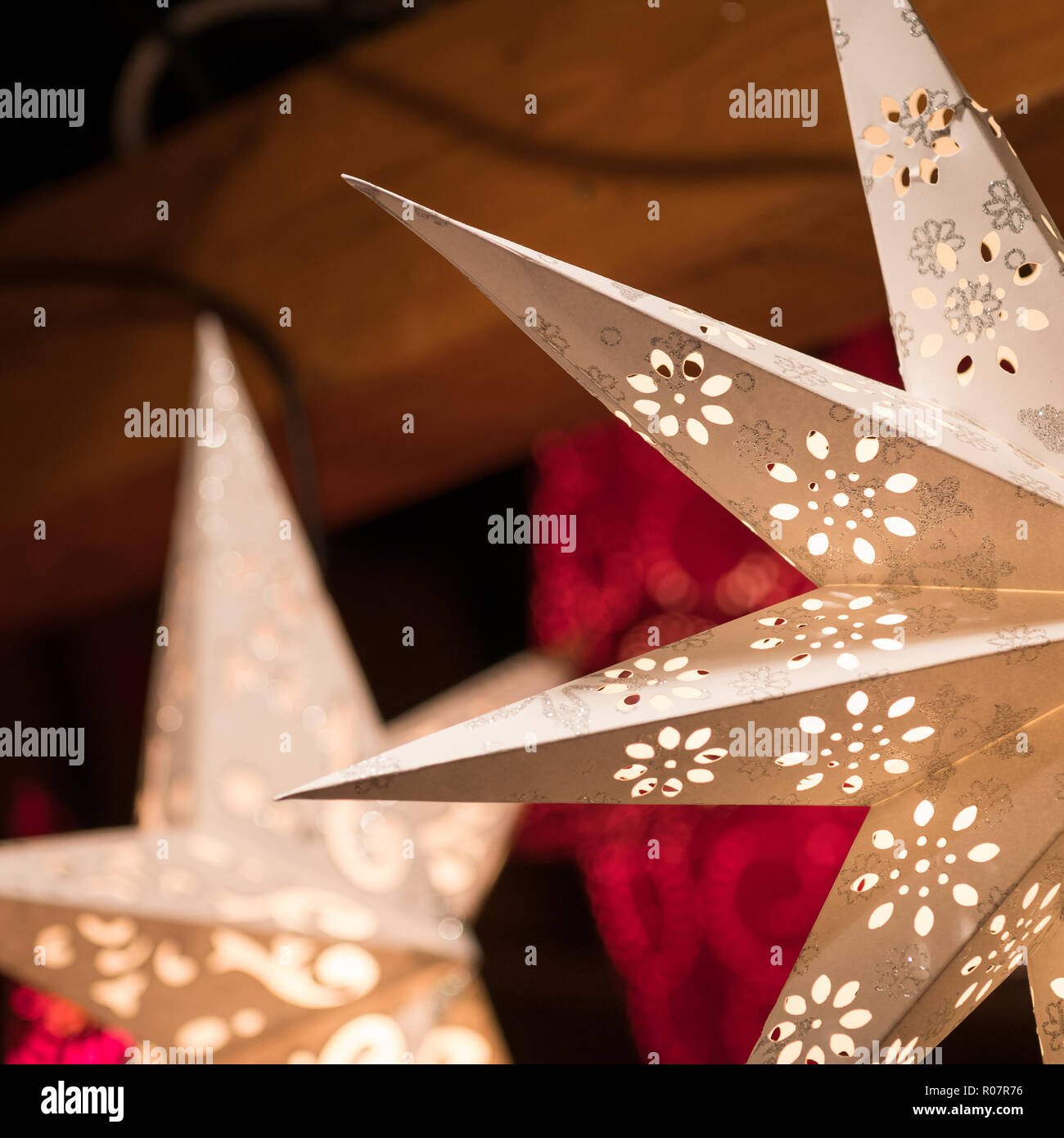 Detail of a star-shaped christmas lantern at the christmas market of Oldenburg in Germany; lights and bokeh Stock Photo