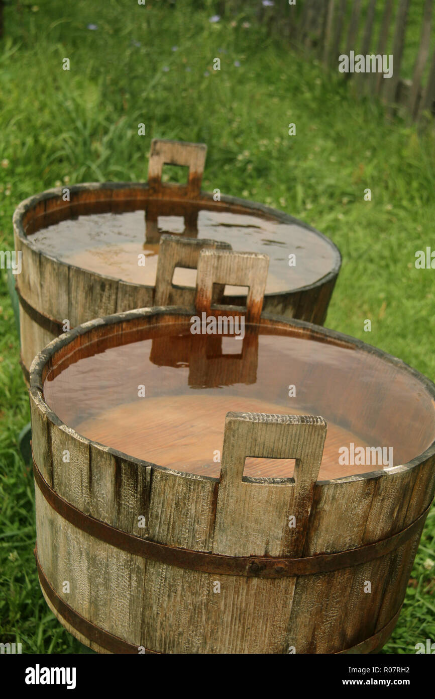 Wooden barrels filled to the top with rain water Stock Photo - Alamy