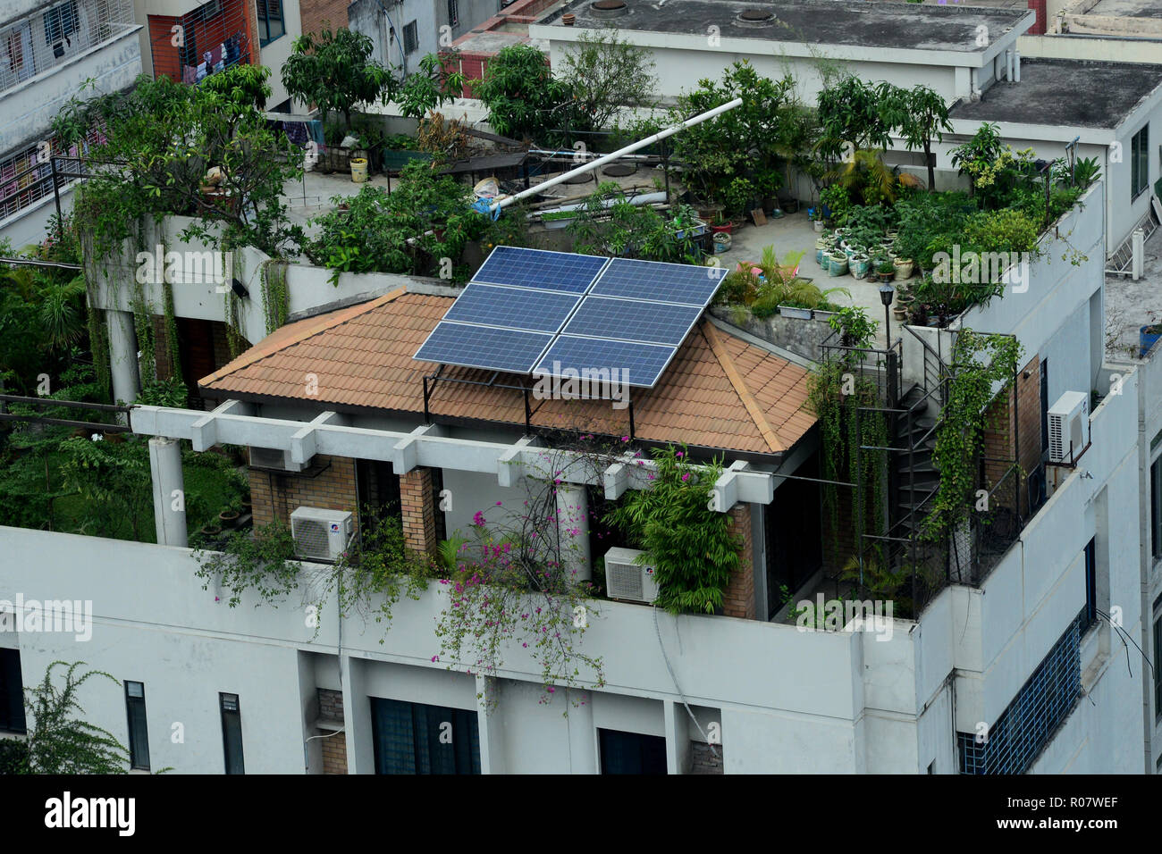 A solar energy panel is seen on the rooftops of buildings in Dhaka