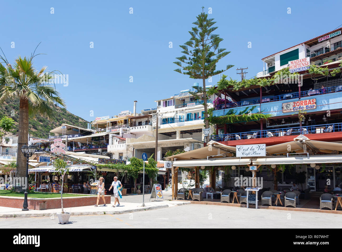 Tavernas on harbour promenade, Agia Galini, Rethimno Region, Crete (Kriti), Greece Stock Photo