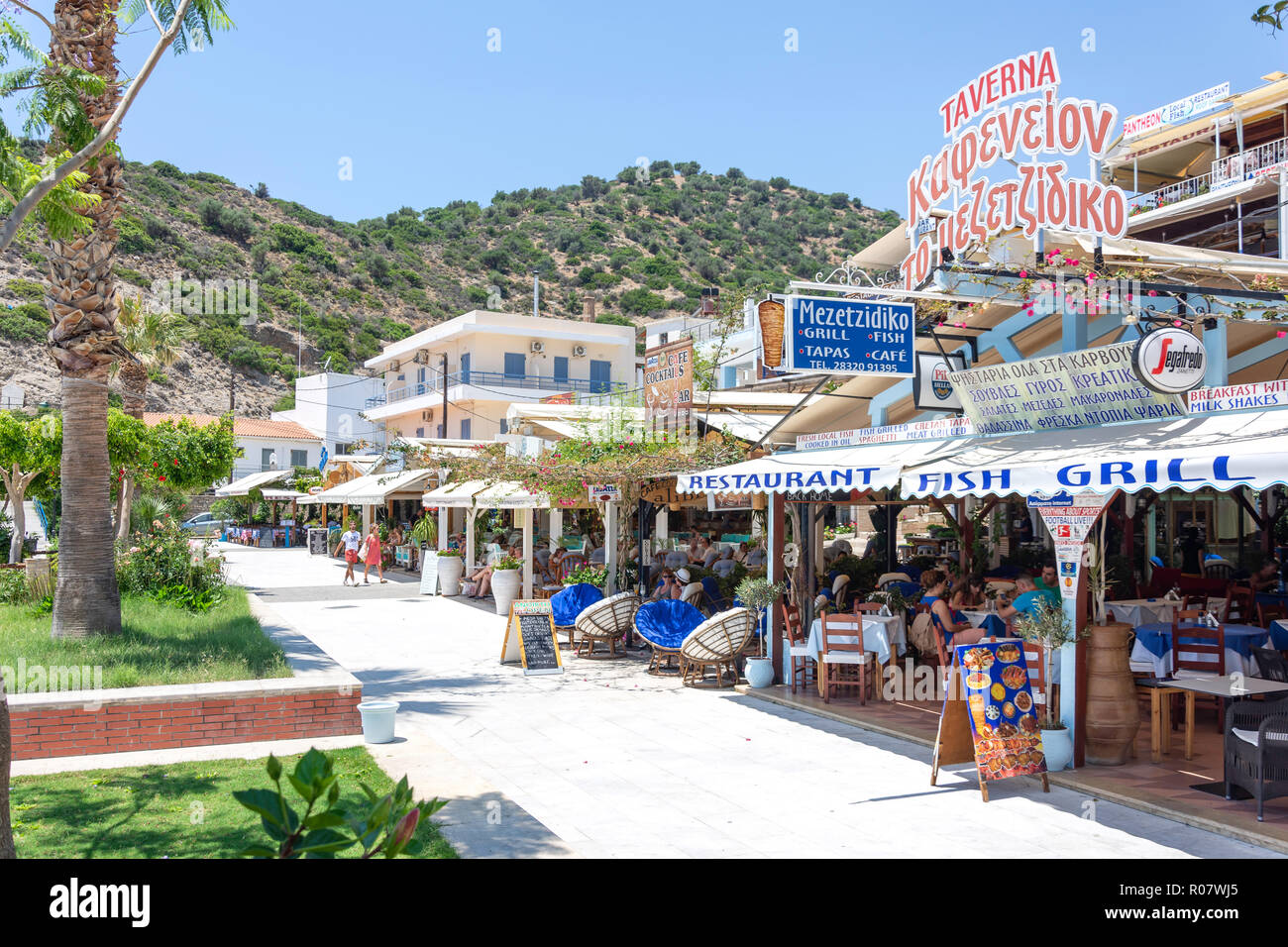 Tavernas on harbour promenade, Agia Galini, Rethimno Region, Crete (Kriti), Greece Stock Photo