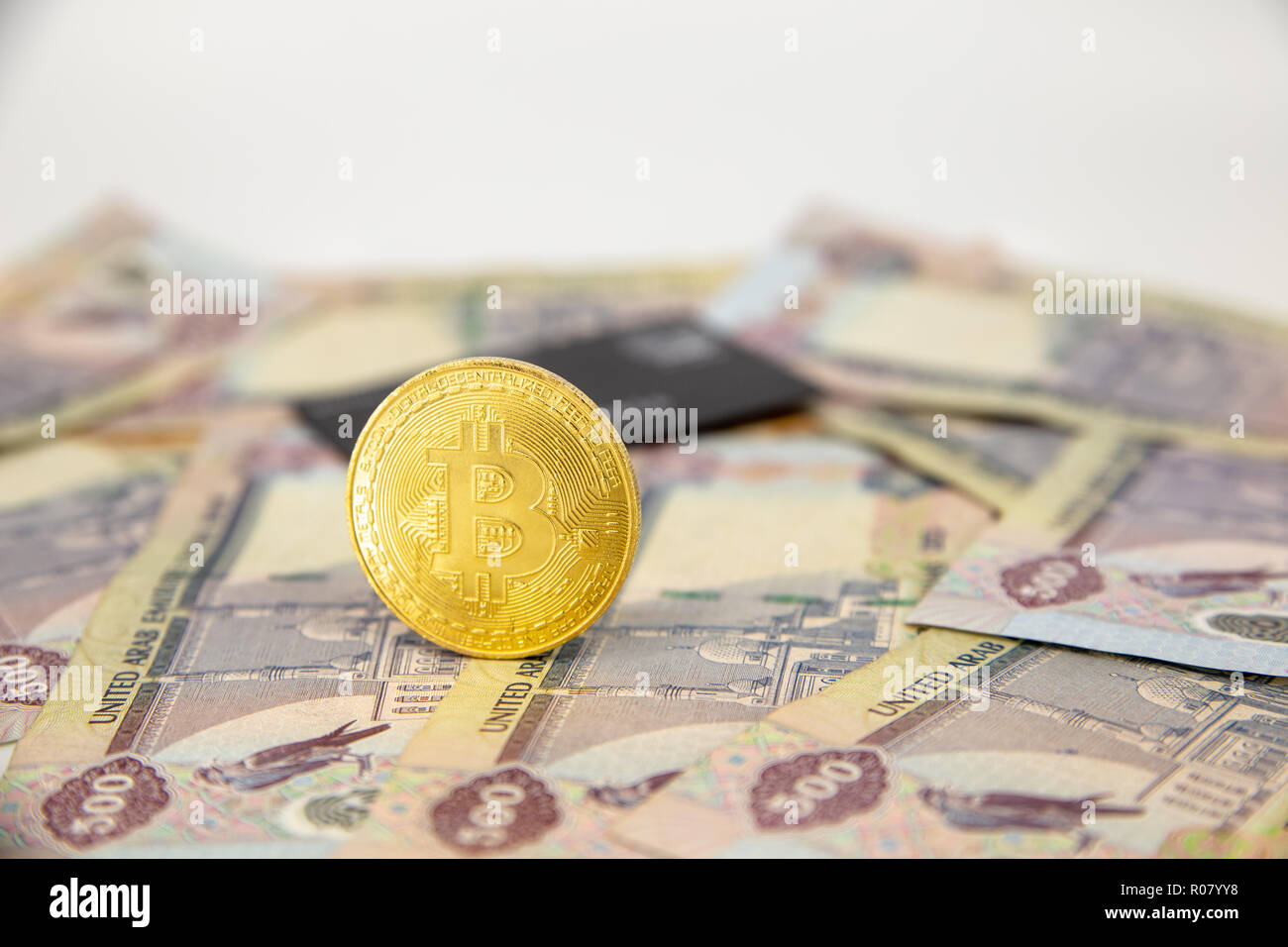 Bitcoin token on top of Dubai, dirham banknotes money. Cryptocurrency  versus paper currency concept, flat lay view Stock Photo - Alamy