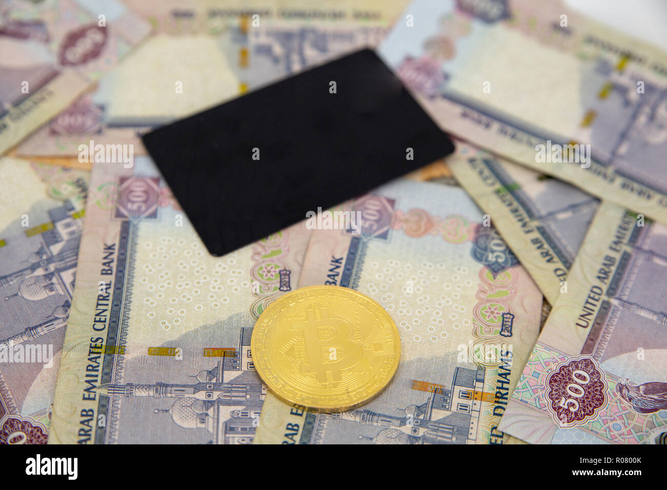 Bitcoin token on top of Dubai, dirham banknotes money. Cryptocurrency  versus paper currency concept, flat lay view Stock Photo - Alamy