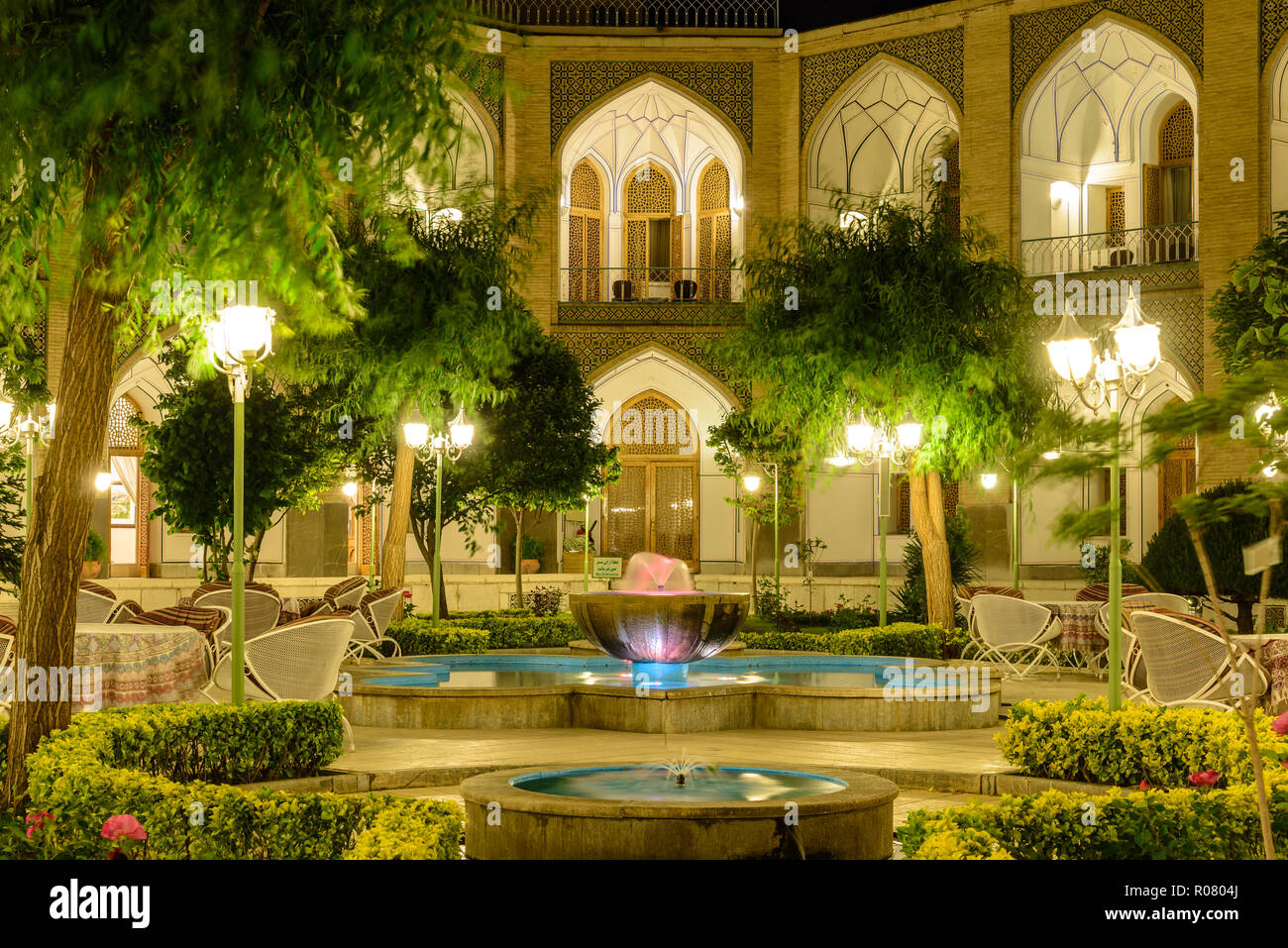 ISFAHAN, IRAN - APRIL 25, 2015: Illuminated Garden of Hotel Abbasi, ancient caravanserai Stock Photo