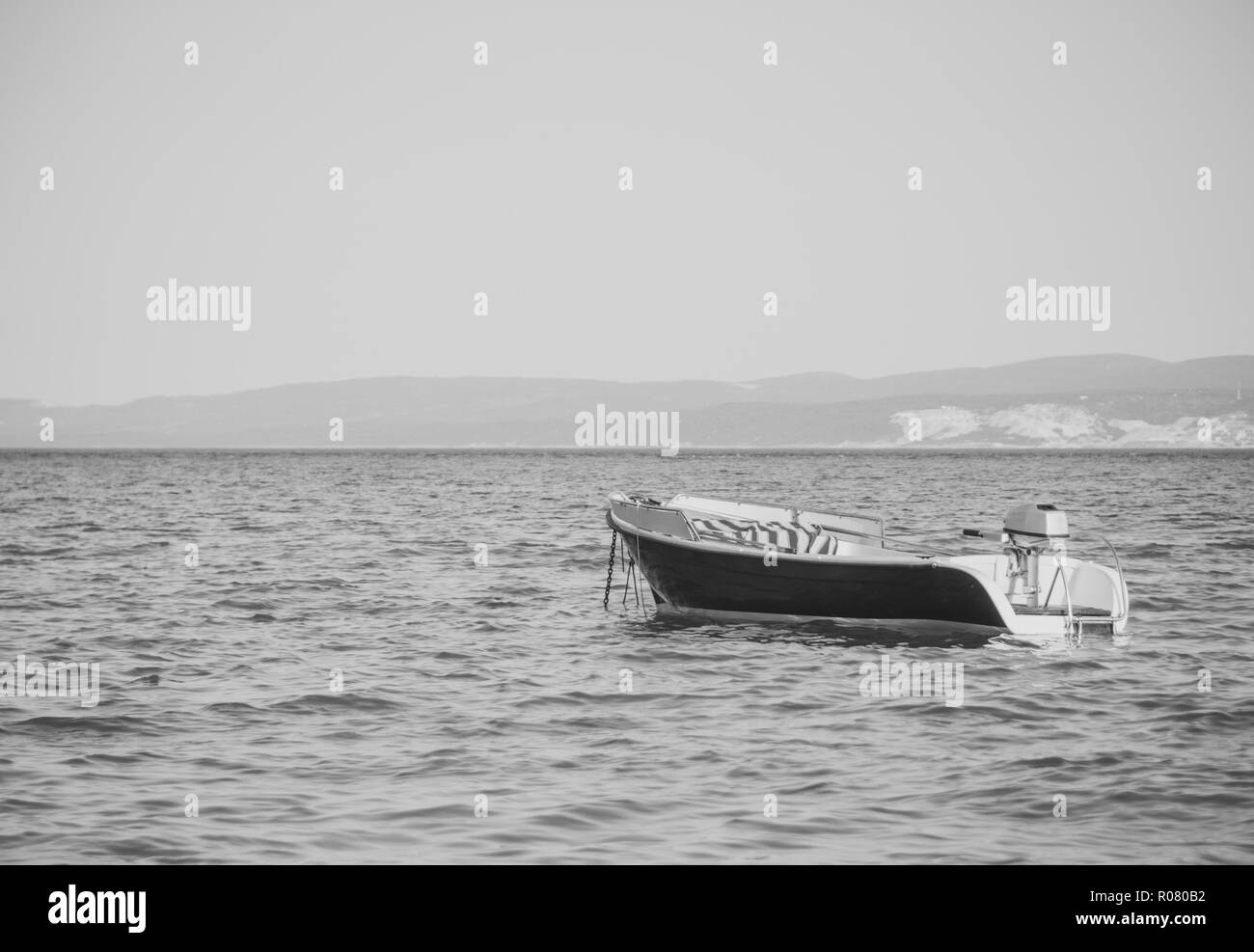 Lonely boat ocean Black and White Stock Photos & Images - Alamy