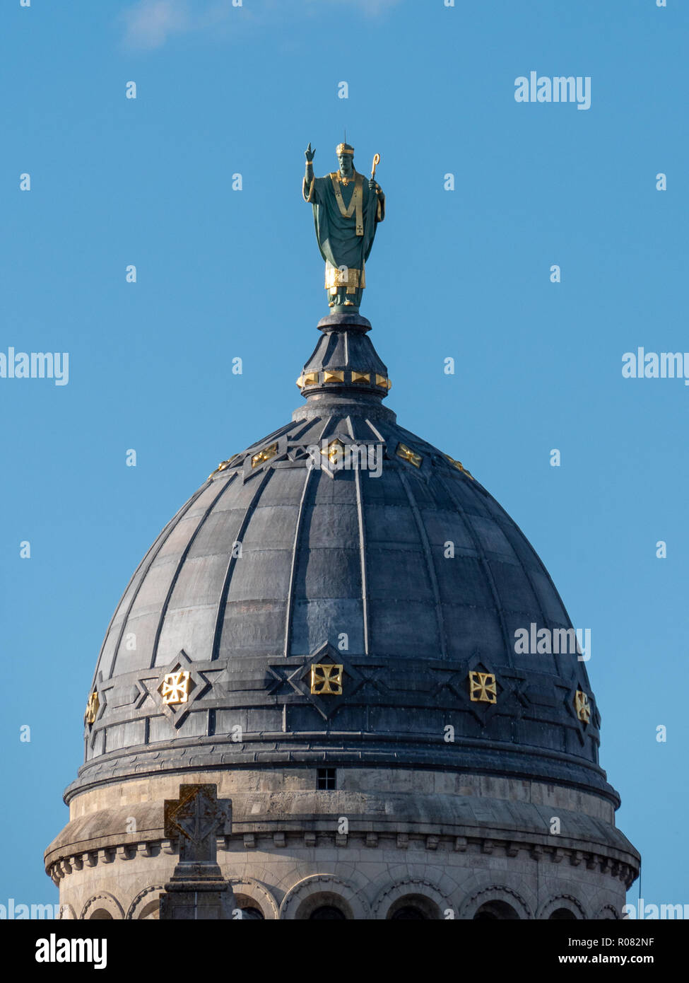 Statue above the basilica of St Martin. It's a Roman Catholic basilica dedicated to Saint Martin of Tours, in France, on whose tomb it was built. Stock Photo