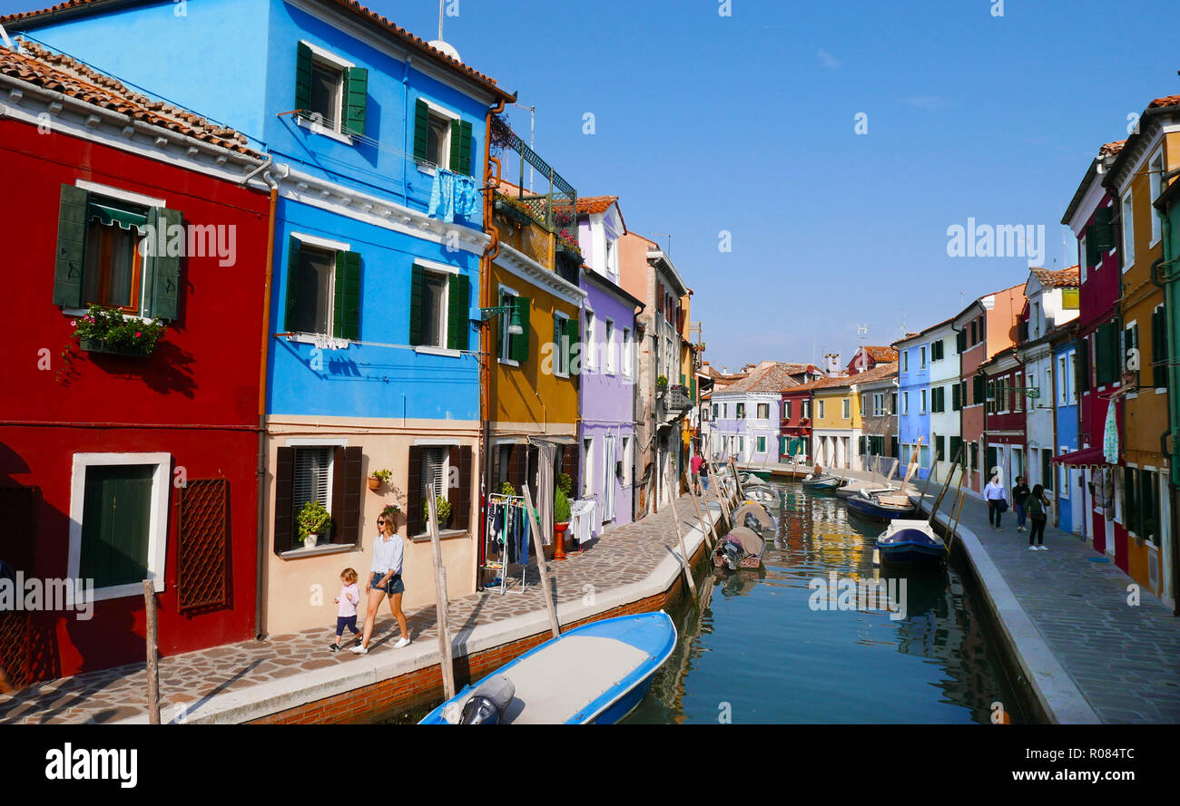 Canal view of the brightly painted house on the island of Burano in the Venetian Lagoon Stock Photo