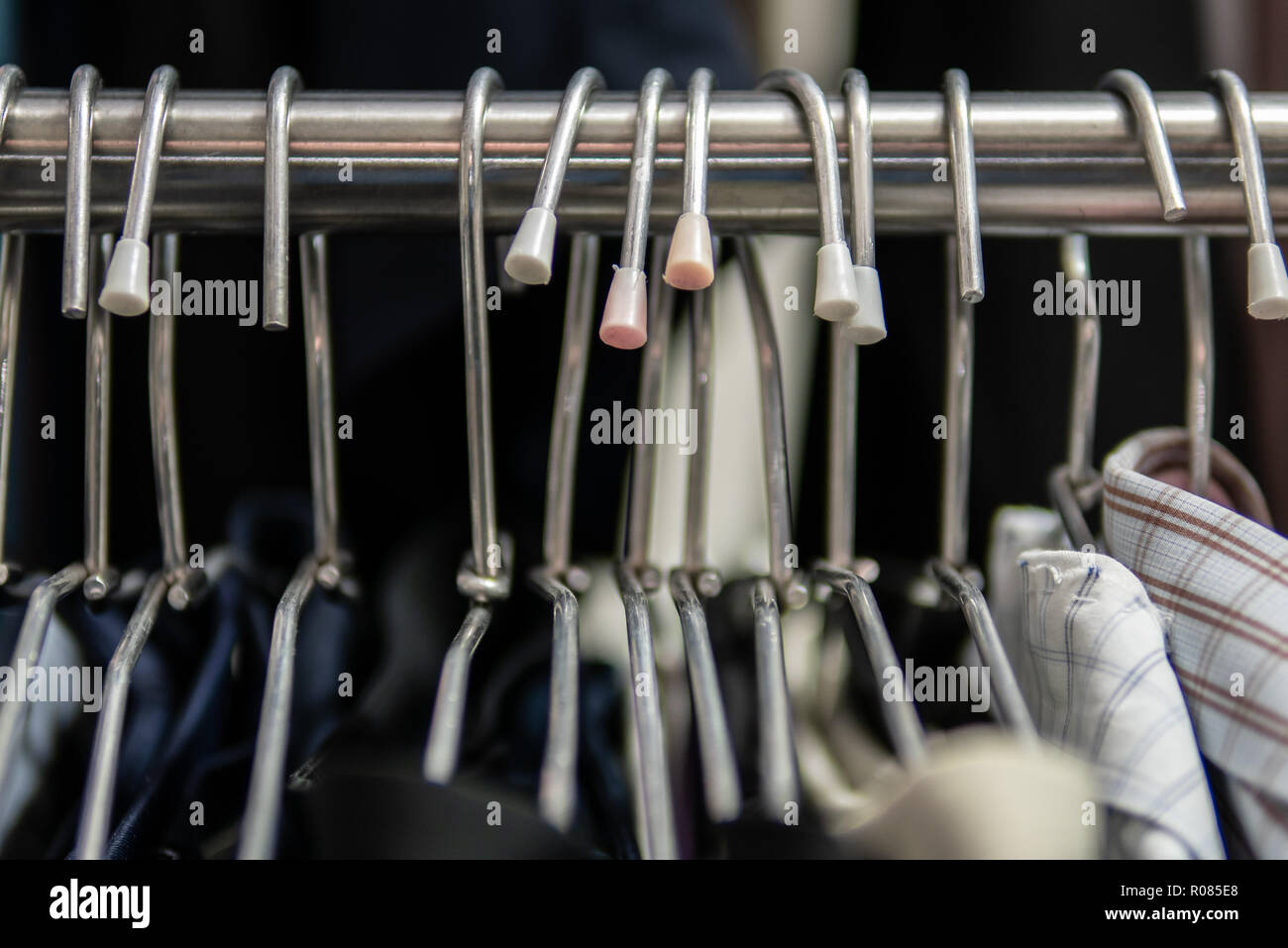 Clothes hangers on clothes rack Stock Photo