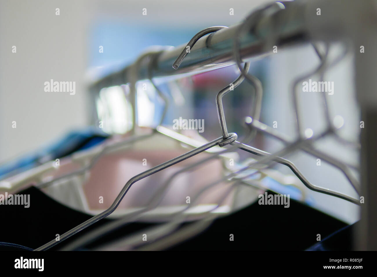 Clothes hangers on clothes rack Stock Photo