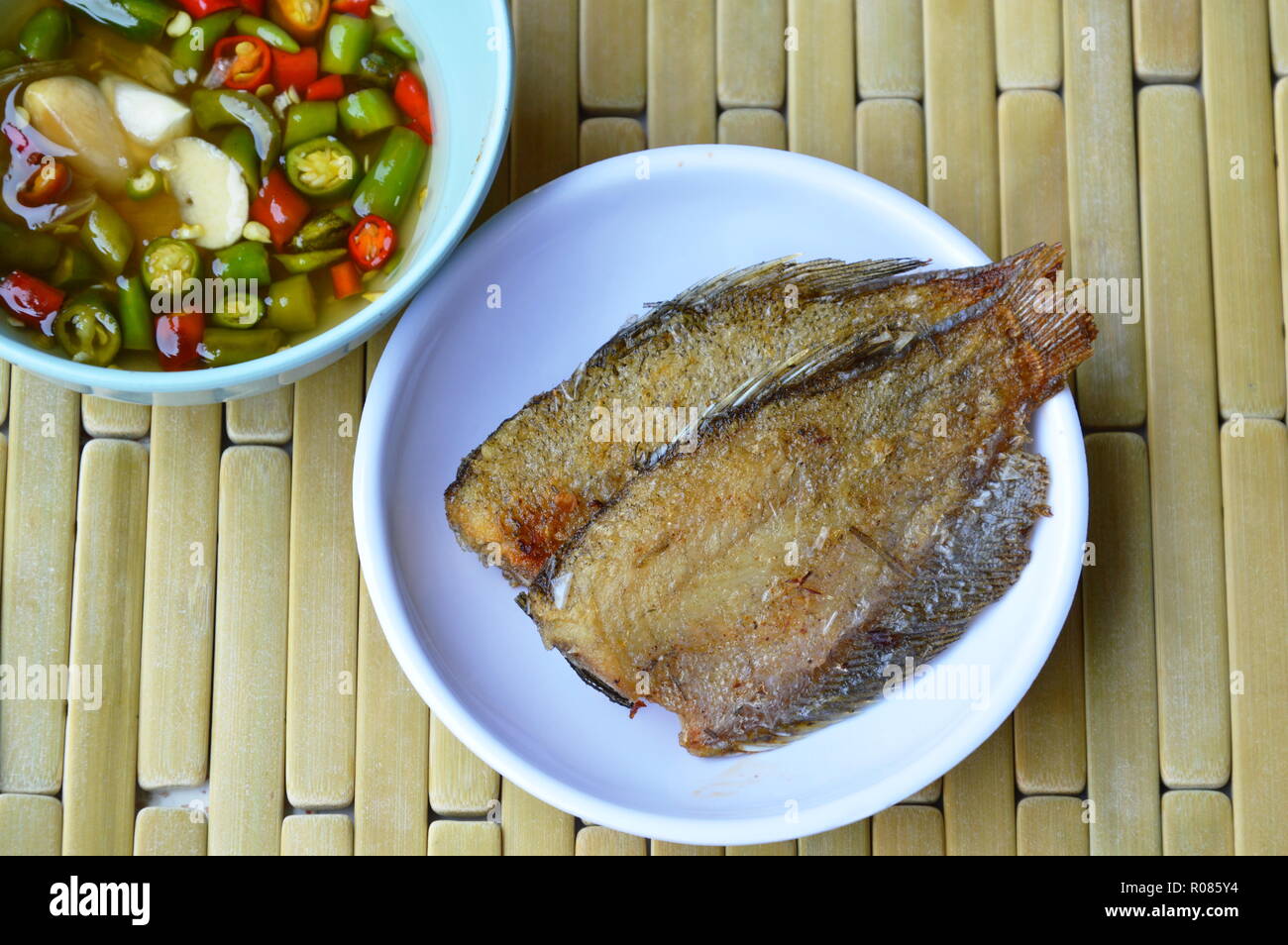solid frying fish dipping with chili sauce Stock Photo Alamy