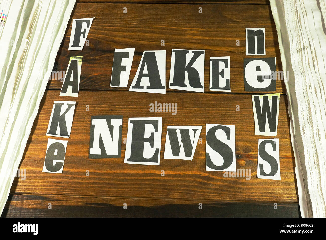 Disinformation and alternative facts. Newspaper letters used to spell out FAKE NEWS. Stock Photo