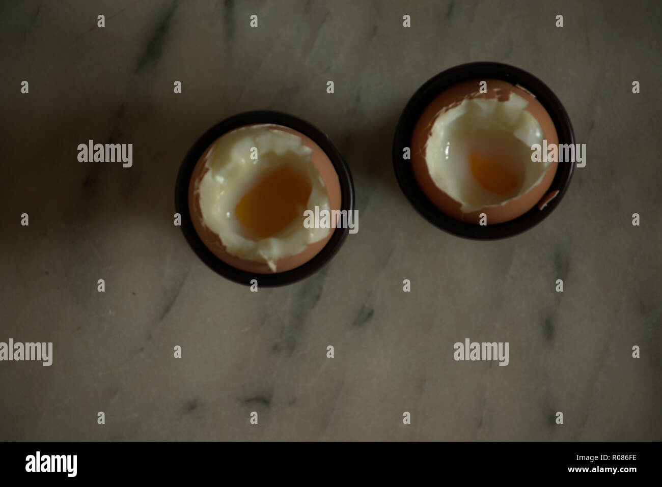 Two soft boiled eggs in egg cups Stock Photo