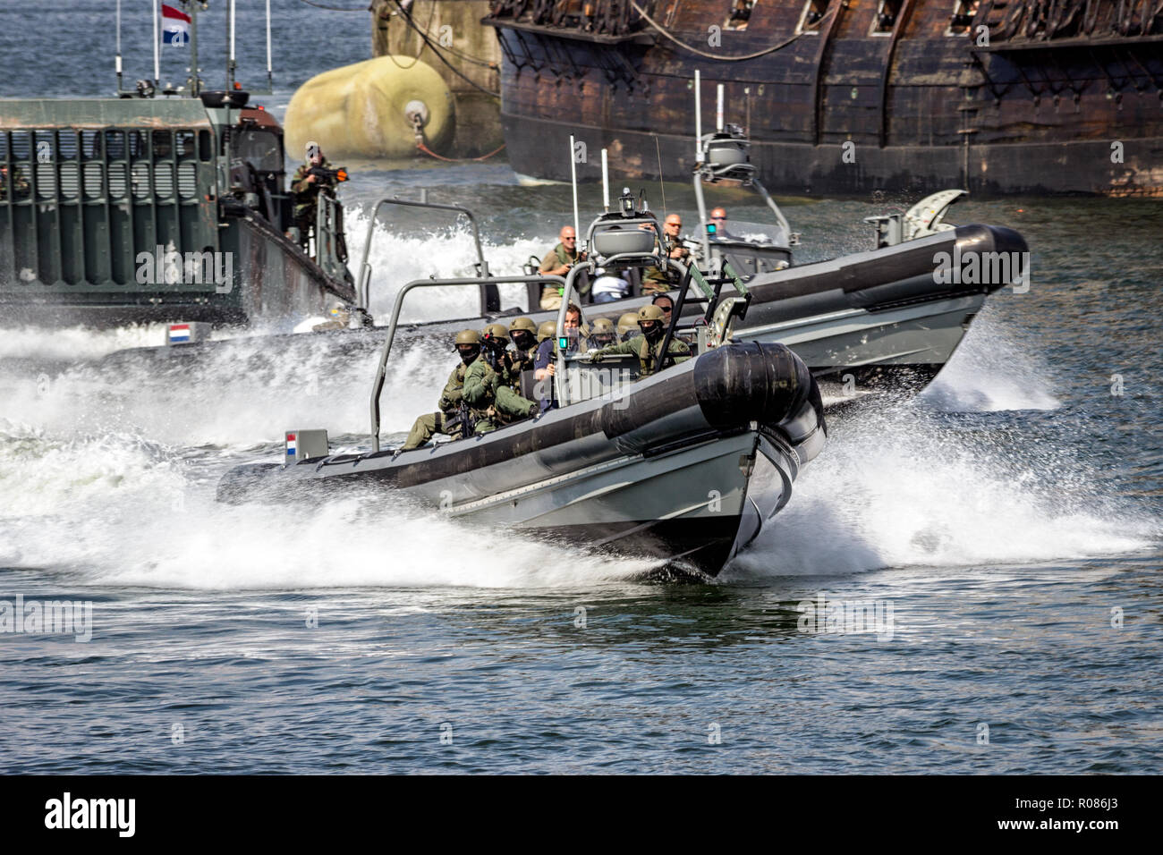 DEN HELDER, THE NETHERLANDS - JUL 7, 2012: Dutch Marines in a MST 1000 Enforcer speedboat during an assault demo at the Dutch Navy Days. Stock Photo