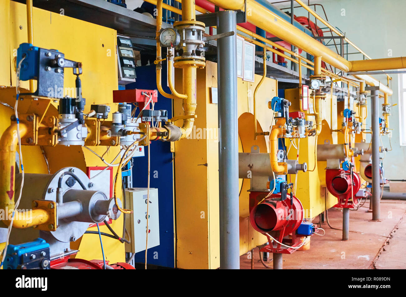 Boiler with four large boilers yellow and red and blue burners Stock