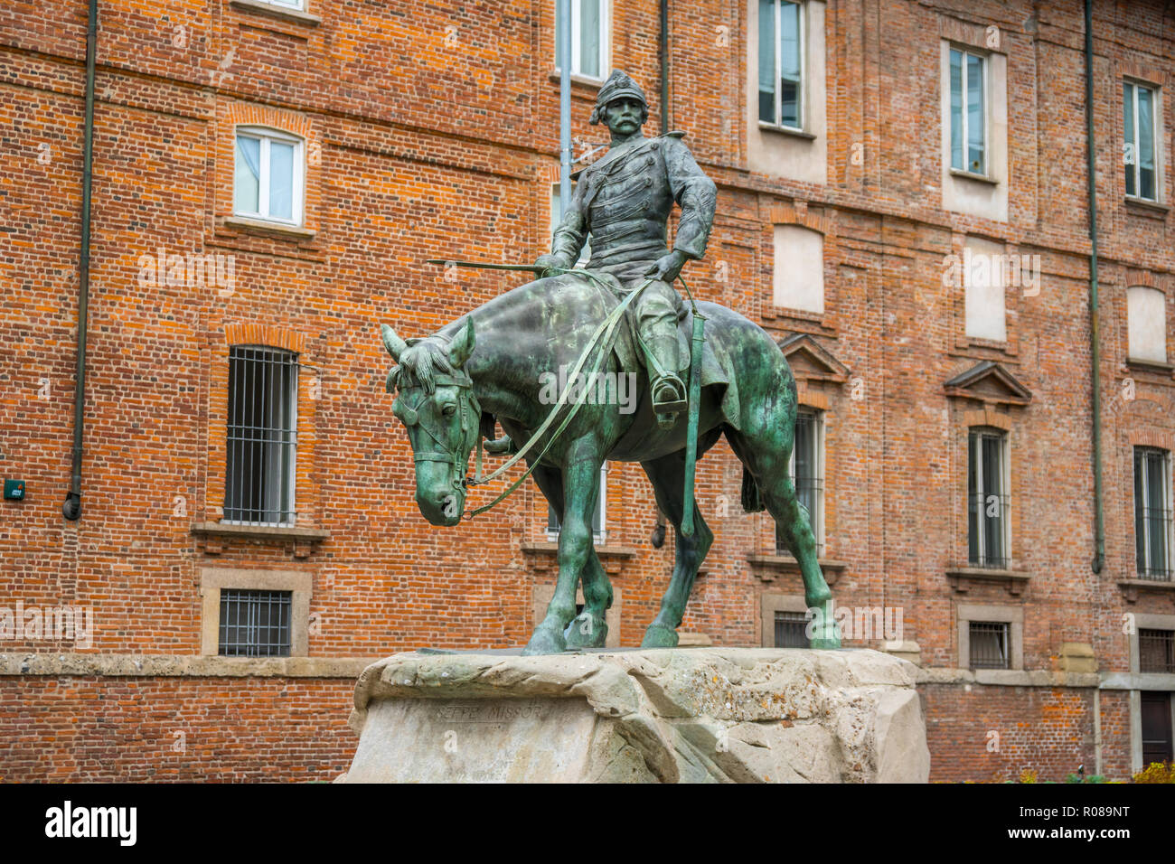 Milan, Italy - 14.08.2018: The bronze Statue of Giuseppe Missori on horse with red brick wall in background and near Piazza de Duomo in historical cen Stock Photo