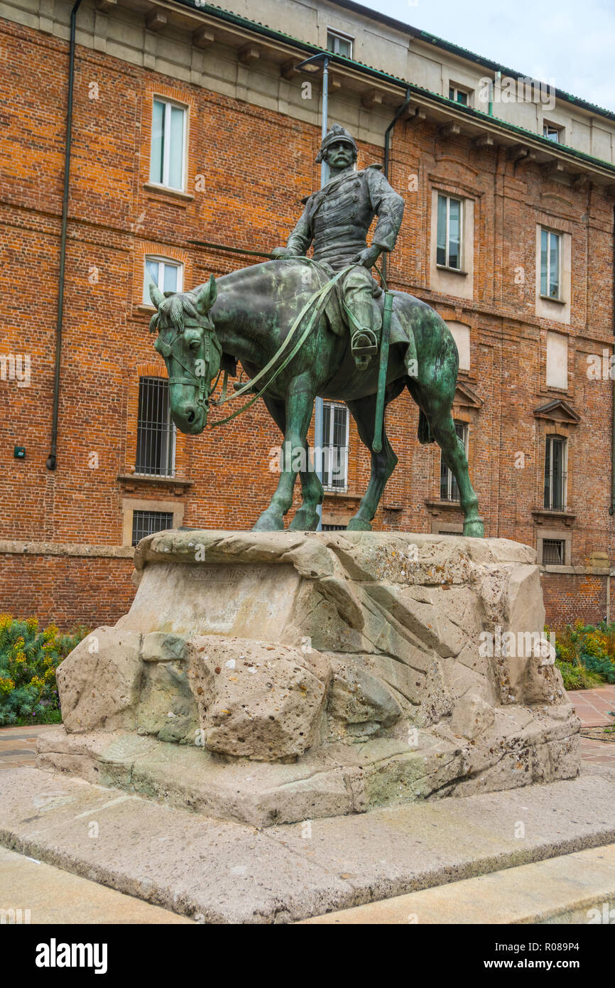 Milan, Italy - 14.08.2018: The bronze Statue of Giuseppe Missori on horse with red brick wall in background and near Piazza de Duomo in historical cen Stock Photo