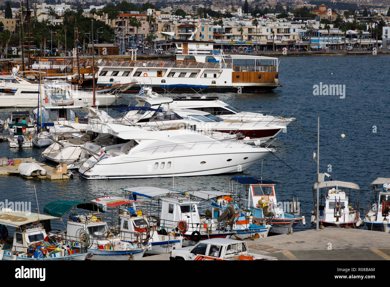 Luxury yachts mix with Cypriot traditional fishing boats in Paphos harbour, Cyprus October 2018 Stock Photo