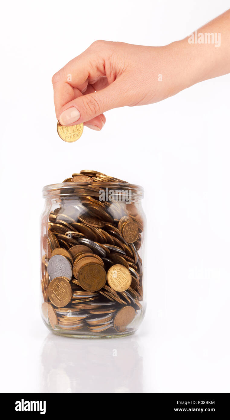 hand put coin jar with coins isolated on white Stock Photo Alamy