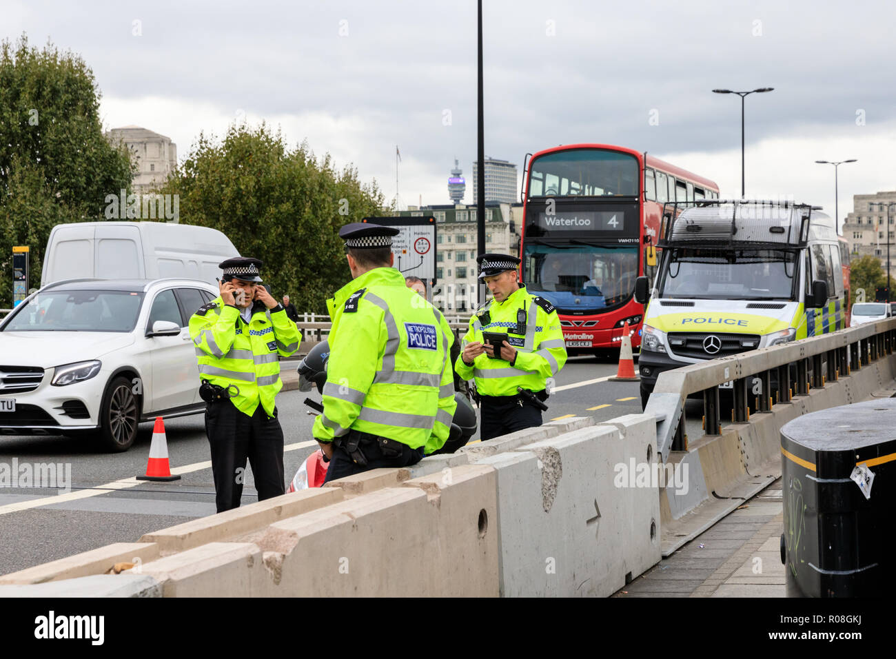 Metropolitan Police officer stop cars and speak to drivers during a stop and search security measure in Waterloo Bridge, London Stock Photo