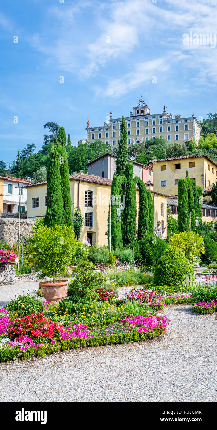 Vertical photo with view on famous villa Garzoni. Villa is built in Tuscany Italy. Nice color garden is in front with several cypress trees and many f Stock Photo