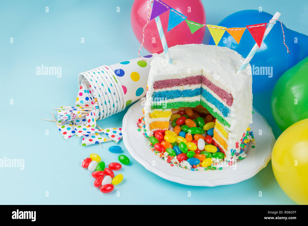Rainbow pinata cake with candies - birthday background, card, concept - copy space Stock Photo