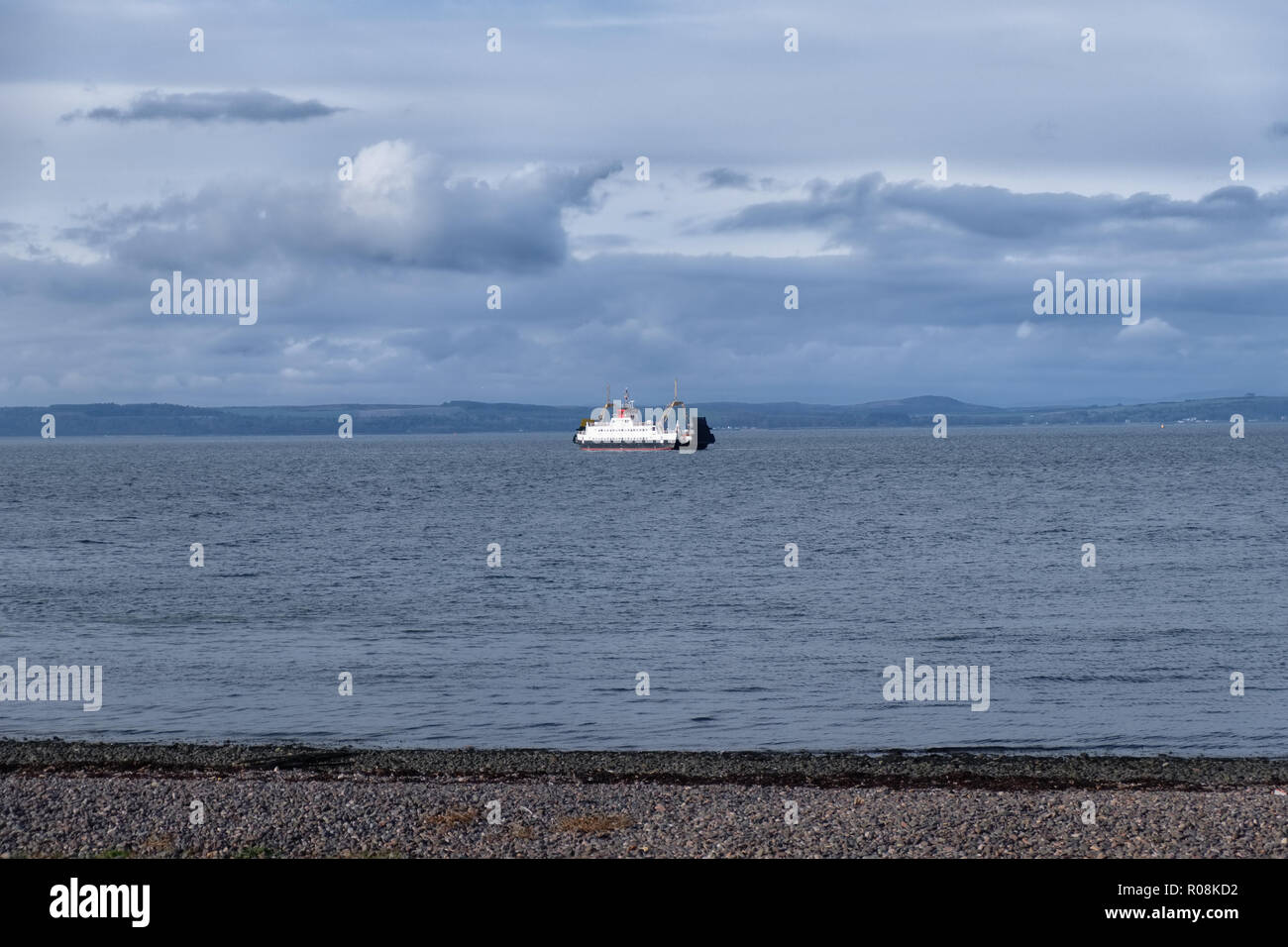 On a cold Octobers day in Largs looking over the water  a car ferry sits waiting to enter Largs Pier. Stock Photo