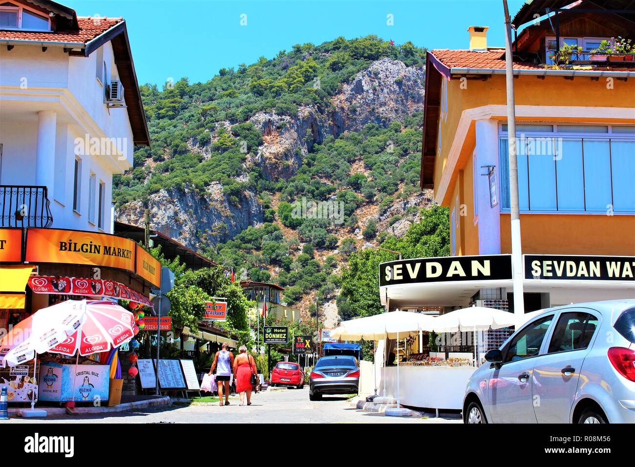 Dalyan, Turkey - July 7th 2018: Street view in Dalyan town, Turkey, with mountain view in the background. Stock Photo