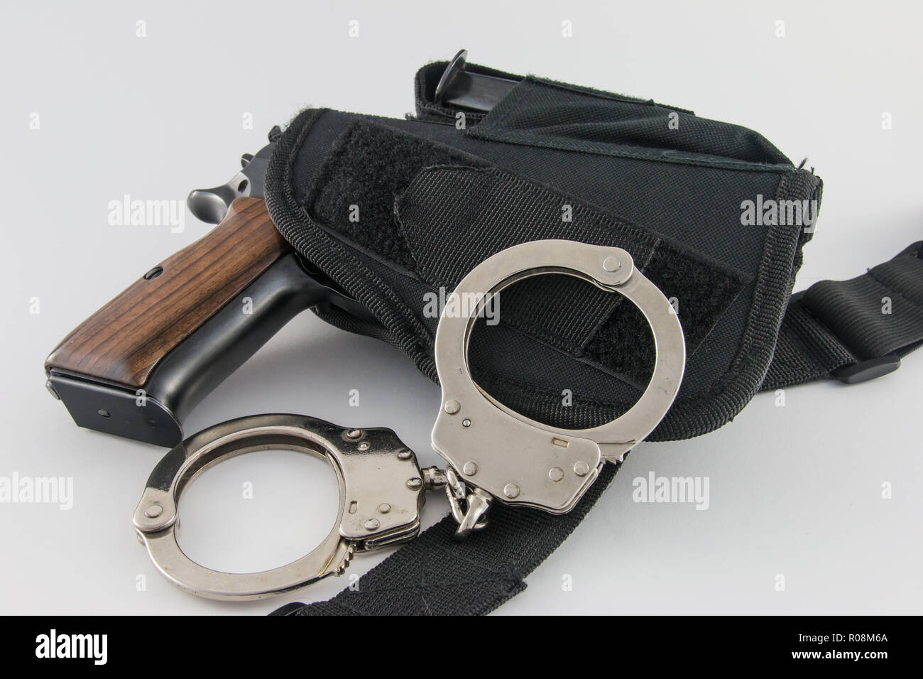 Handgun in tactical SWAT holster with handcuffs Stock Photo Alamy