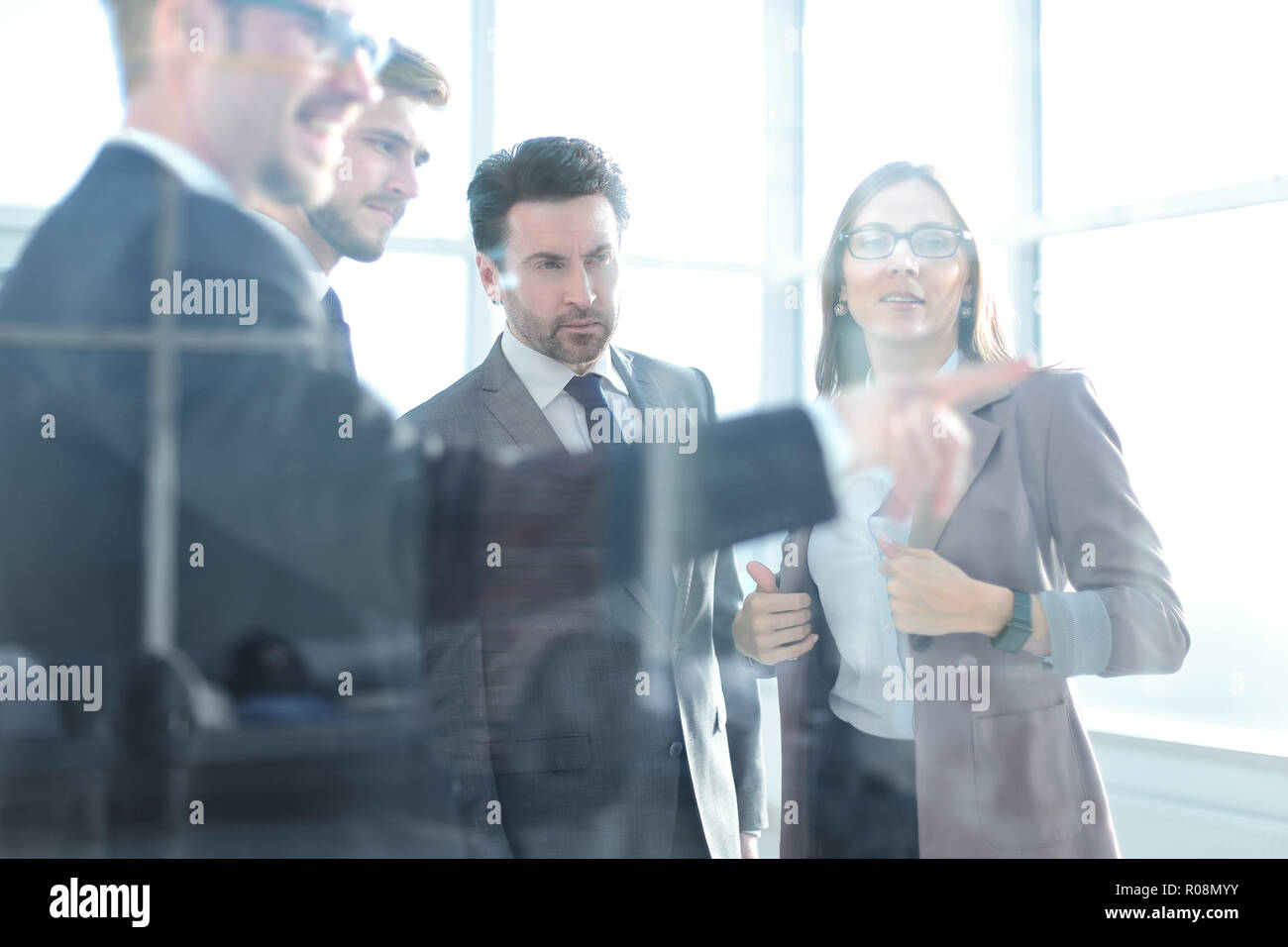 Image of a businessman's hand pointing a flowchart on the glass Stock Photo