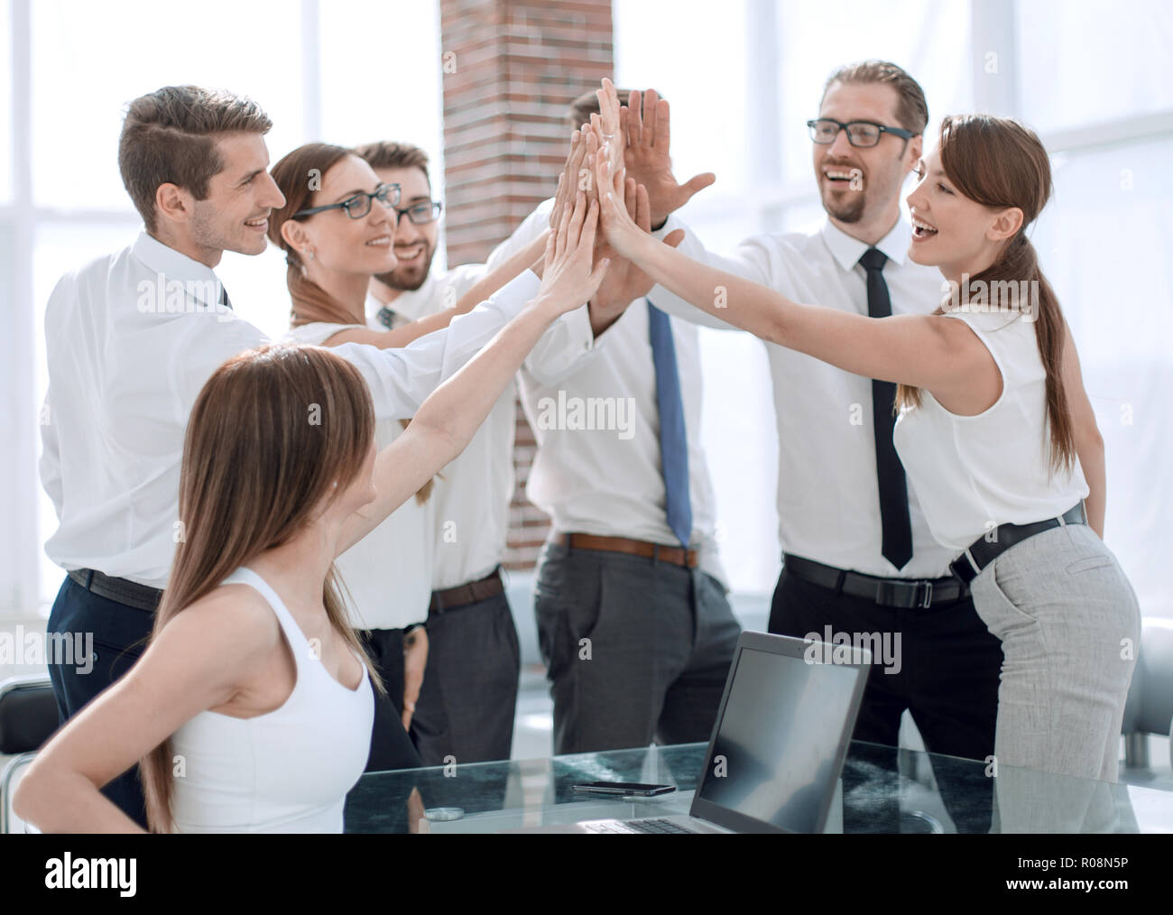 young business team giving each other high five.the concept of teamwork
