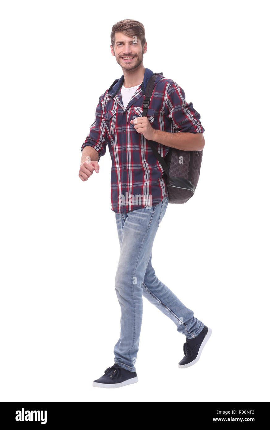 in full growth. a handsome male student steps forward.isolated on white ...