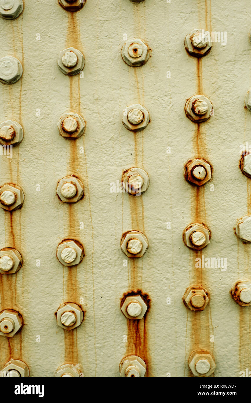 Rusting metal bolts background Stock Photo