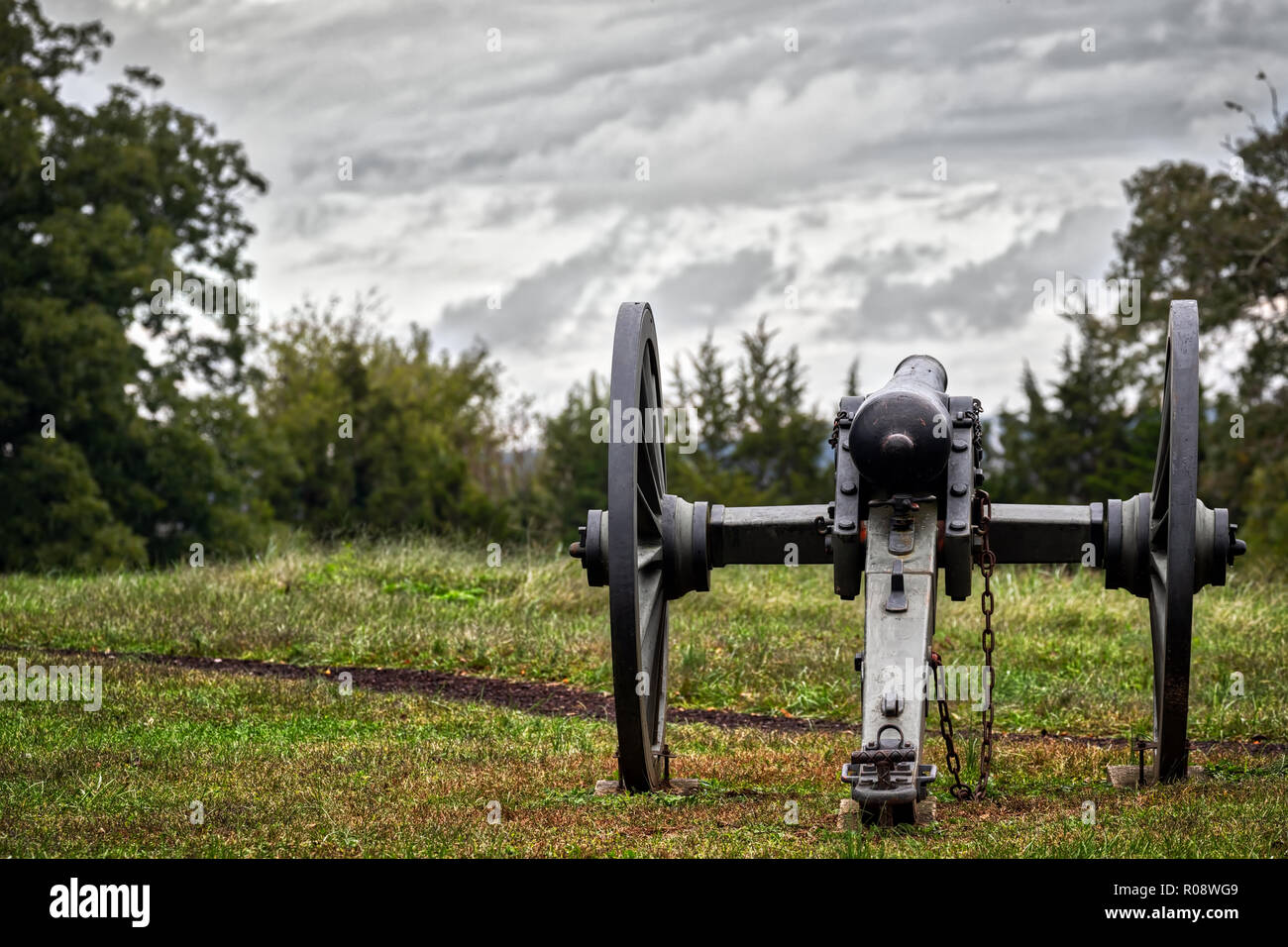 A long silent Civil War cannon sits in a Virginia field. Stock Photo