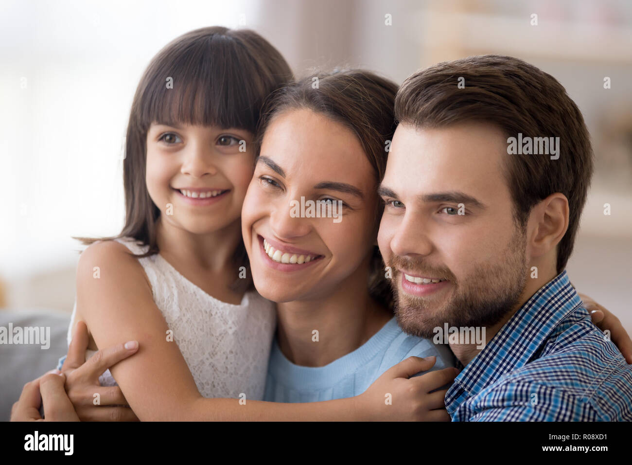 Diverse family with little daughter looking at camera Stock Photo