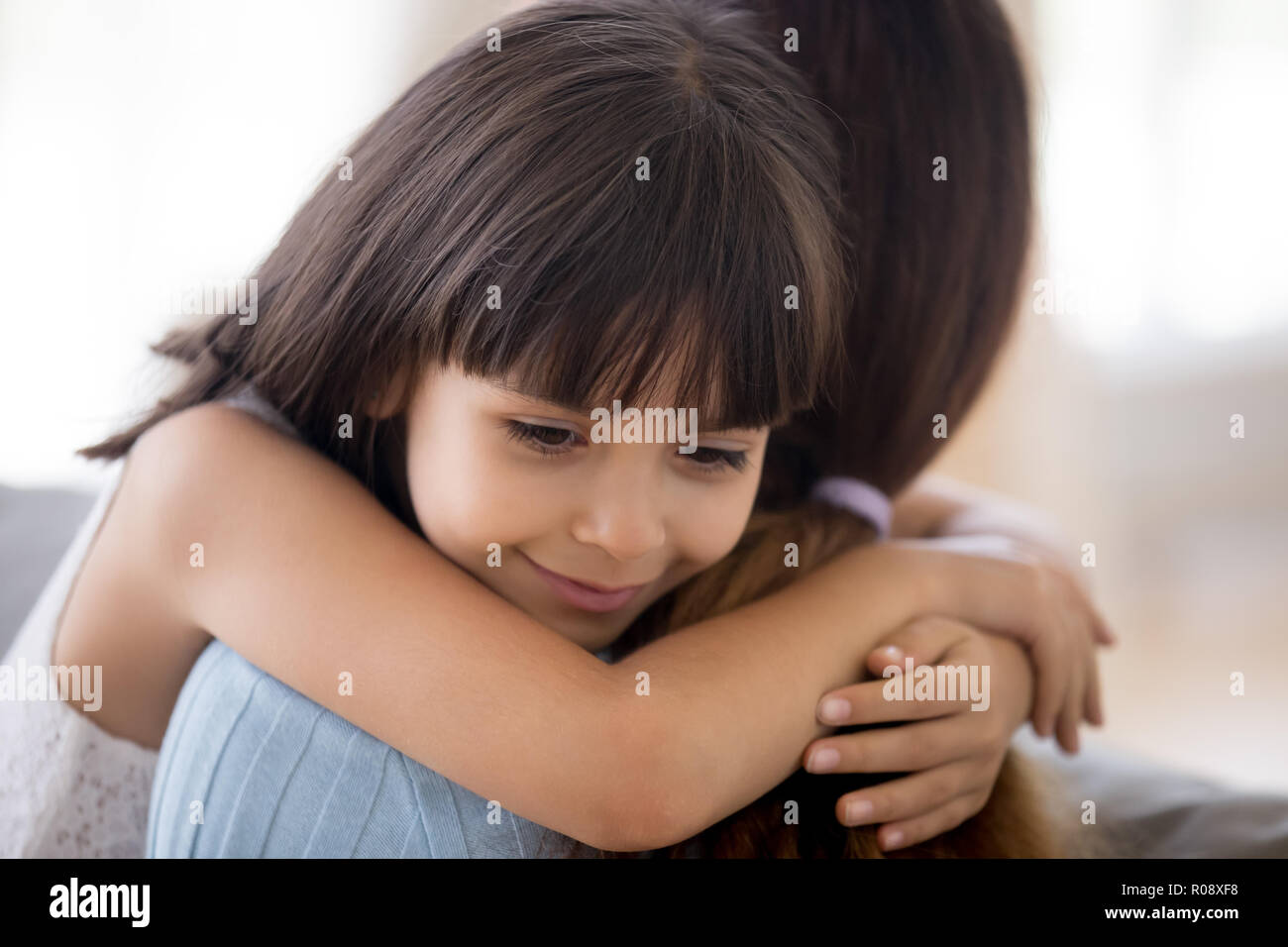 Sincere daughter hugging mother expressing love and devotion Stock Photo